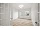 Bright, empty bedroom with two windows and light LVP flooring at 137 Summerwind Dr, Summerville, SC 29486