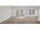 Open living room with wood-look floors, recessed lights, and sliding glass doors to the backyard at 137 Summerwind Dr, Summerville, SC 29486