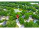 Aerial view of home nestled within lush greenery and a pond at 1394 Center Lake Dr, Mount Pleasant, SC 29464