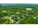 A birds-eye view displays a home near a lake, surrounded by lush trees, in an established neighborhood at 1394 Center Lake Dr, Mount Pleasant, SC 29464