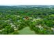 An aerial shot showcases a property near a tranquil lake, enveloped by lush, mature trees at 1394 Center Lake Dr, Mount Pleasant, SC 29464