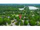 Aerial view shows a home nestled in a lush, mature neighborhood near a lake at 1394 Center Lake Dr, Mount Pleasant, SC 29464