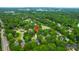 An aerial view features a home near a calm lake, with lush trees and the wider neighborhood visible at 1394 Center Lake Dr, Mount Pleasant, SC 29464
