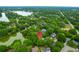 Aerial view of a neighborhood with tree-lined streets, a lake, and a home in the canopy at 1394 Center Lake Dr, Mount Pleasant, SC 29464