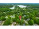 An aerial image highlights a home near a lake, surrounded by lush, mature trees in a neighborhood at 1394 Center Lake Dr, Mount Pleasant, SC 29464