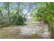 Spacious backyard with mature trees offering plenty of shade and a patio area, perfect for outdoor activities at 1394 Center Lake Dr, Mount Pleasant, SC 29464