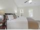 Bedroom featuring a plush bed, two windows with neighborhood views, a ceiling fan, and bedside tables at 1394 Center Lake Dr, Mount Pleasant, SC 29464