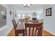 Bright dining room with hardwood floors adjacent to living area with fireplace at 1394 Center Lake Dr, Mount Pleasant, SC 29464