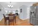 View of dining room showcasing wood floors and modern stainless steel refrigerator at 1394 Center Lake Dr, Mount Pleasant, SC 29464