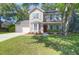 Charming two-story home featuring neutral siding, an attached garage, and well-manicured front yard at 1394 Center Lake Dr, Mount Pleasant, SC 29464