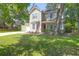 Charming two-story home with an inviting front porch, mature trees, and a well-maintained lawn at 1394 Center Lake Dr, Mount Pleasant, SC 29464