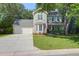 Inviting home exterior features a manicured lawn and a spacious driveway with lush green trees at 1394 Center Lake Dr, Mount Pleasant, SC 29464