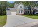 Charming two-story home with a well-maintained lawn and attached two-car garage at 1394 Center Lake Dr, Mount Pleasant, SC 29464