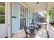 Inviting front porch with charming wicker seating and views of the neighborhood at 1394 Center Lake Dr, Mount Pleasant, SC 29464