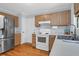 Efficient kitchen with wooden cabinets, white appliances, and hardwood flooring at 1394 Center Lake Dr, Mount Pleasant, SC 29464