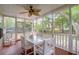 Relaxing screened porch with dining table and chairs, perfect for outdoor meals at 1394 Center Lake Dr, Mount Pleasant, SC 29464