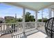 Charming balcony view with wrought iron railings and a comfortable hanging chair at 142 President St, Charleston, SC 29403