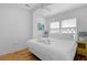 Comfortable bedroom with decorative headboard, ceiling fan, and natural light from the window at 142 President St, Charleston, SC 29403
