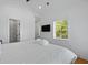 Inviting bedroom with hard wood floors, a view to the bathroom, and great natural light at 142 President St, Charleston, SC 29403