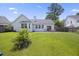 Well-maintained backyard featuring a lush lawn, mature landscaping, patio area, and privacy fence on a sunny day at 1470 Ashley Gardens Blvd, Charleston, SC 29414
