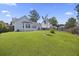Spacious backyard with a well-kept lawn, charming patio area, fenced perimeter, and lush surrounding greenery at 1470 Ashley Gardens Blvd, Charleston, SC 29414