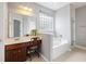 Bright bathroom featuring vanity, a large mirror, separate tub and shower, and lots of natural light at 1470 Ashley Gardens Blvd, Charleston, SC 29414