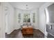 Bright dining nook with bay window, slate floors, gray sofa, and wooden chest for storage at 1470 Ashley Gardens Blvd, Charleston, SC 29414