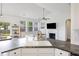 Bright kitchen with a gray countertop island, white cabinets, and open access to the living room at 1470 Ashley Gardens Blvd, Charleston, SC 29414