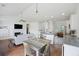 Open-concept living space featuring a fireplace and dining area with kitchen in the background at 1470 Ashley Gardens Blvd, Charleston, SC 29414