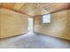 Unfinished basement with concrete floor, plywood walls, and a doorway offers potential at 1515 Mulberry St, Charleston, SC 29407
