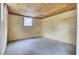 Unfinished basement with concrete floor, plywood walls, and a window offers potential at 1515 Mulberry St, Charleston, SC 29407