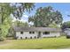 Charming single-story home featuring a landscaped lawn, a welcoming front door with a wreath, and light gray siding at 1515 Mulberry St, Charleston, SC 29407