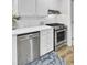 Close up of modern dishwasher and stove, complemented by white cabinets and butcher block counters at 1515 Mulberry St, Charleston, SC 29407