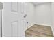 A practical laundry room featuring wood-look floors and a door for easy access at 1515 Mulberry St, Charleston, SC 29407