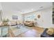 Bright living room features hardwood floors, a neutral color palette, and plenty of natural light at 1515 Mulberry St, Charleston, SC 29407