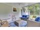 A screened sunroom has cushioned seating for relaxation and views of the backyard at 1515 Mulberry St, Charleston, SC 29407