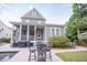 Home exterior featuring an outdoor dining area adjacent to a screened porch at 1566 Lindsey Creek Dr, Mount Pleasant, SC 29466