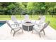 Backyard fire pit surrounded by Adirondack chairs on a tile patio at 1566 Lindsey Creek Dr, Mount Pleasant, SC 29466