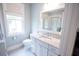 Well-lit bathroom with marble countertop, white cabinets, and a window view at 1566 Lindsey Creek Dr, Mount Pleasant, SC 29466