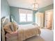 Comfortable bedroom with teal walls, soft carpet, and bright window views at 1566 Lindsey Creek Dr, Mount Pleasant, SC 29466