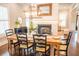 Dining room with fireplace, wood table, black chairs, and decorative mirror at 1566 Lindsey Creek Dr, Mount Pleasant, SC 29466
