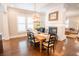 Dining room with fireplace, wood table, black chairs, and modern chandelier at 1566 Lindsey Creek Dr, Mount Pleasant, SC 29466