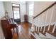 Entryway featuring hardwood floors, a wooden staircase and a baby grand piano at 1566 Lindsey Creek Dr, Mount Pleasant, SC 29466