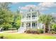 Beautiful two-story home featuring double porches, manicured lawn, and great curb appeal at 1566 Lindsey Creek Dr, Mount Pleasant, SC 29466