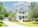 Charming two-story home with double porches, manicured lawn, and inviting curb appeal at 1566 Lindsey Creek Dr, Mount Pleasant, SC 29466