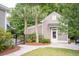 Exterior view of a home with a walkway, dark metal fence, tropical foliage, and a well manicured lawn at 1566 Lindsey Creek Dr, Mount Pleasant, SC 29466