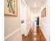 Inviting hallway with hardwood floors and classic wainscoting, leading to various rooms in the home at 1566 Lindsey Creek Dr, Mount Pleasant, SC 29466