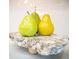 A close-up of three fresh pears on a decorative marble cutting board on the kitchen counter at 1566 Lindsey Creek Dr, Mount Pleasant, SC 29466