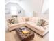 Bright living room with a large sectional sofa, leather ottoman, and neutral decor at 1566 Lindsey Creek Dr, Mount Pleasant, SC 29466