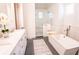 Luxurious main bathroom featuring a soaking tub, glass-enclosed shower, and elegant finishes at 1566 Lindsey Creek Dr, Mount Pleasant, SC 29466